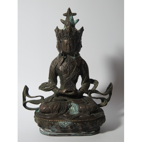 519 - An Indo Chinese Bronze Seated Deity, 20cm