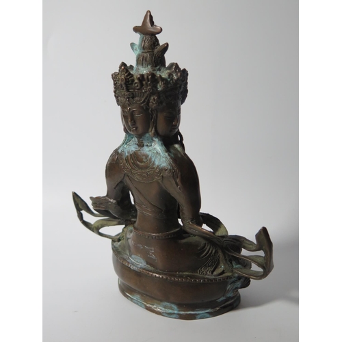 519 - An Indo Chinese Bronze Seated Deity, 20cm