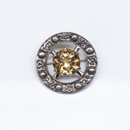 329 - A SILVER AND TOPAZ BROOCH