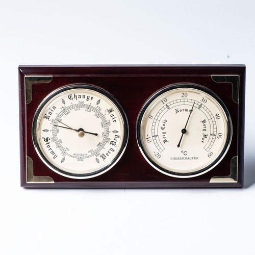69 - A BAROMETER AND THERMOMETER SET, MODERNThe pair of matching dials 10cm in diameter on a stepped ebon... 