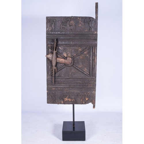 90 - A DOGON STYLE GRANARY DOORThe door carved with figures, the handle carved as a crocodile210cm high, ... 