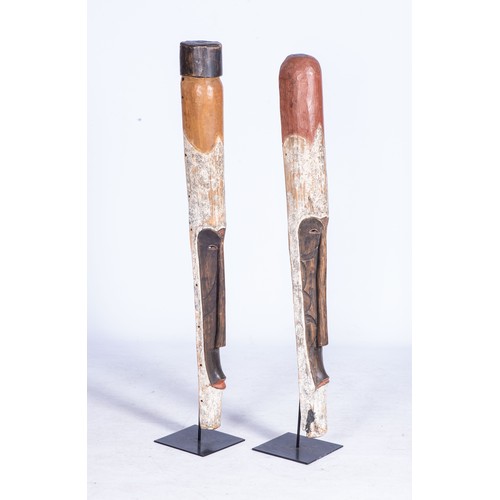 89 - A PAIR OF WOODEN MASKSTubular hand-carved, each secured on a steel base.The larger 121cm, the other ... 