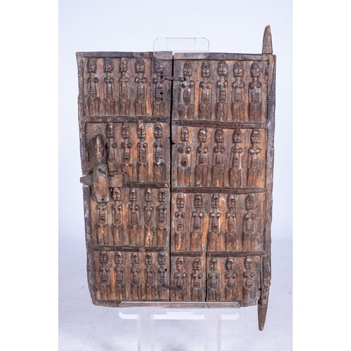 91 - A DOGON STYLE GRANARY DOORThe door carved with figures of women 105cm high including perspex base,50... 