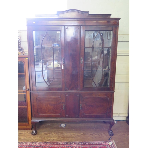 49 - A 1930s mahogany display cabinet, the raised back over a pair of glazed doors and panelled centre ab... 