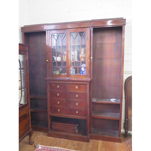 50 - A mahogany breakfront bookcase cabinet, the moulded cornice over a pair of glazed doors above eight ... 