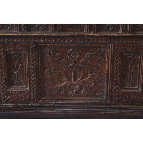 29 - An Italian Oak Coffer. Possibly 16th century. The façade carved with panels of flowering foliage wit... 