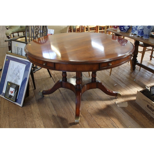 4 - A modern Mahogany veneered centre table. In 19th century style. The circular top fitted with four dr... 