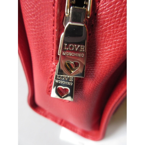 47 - Love Moschino, red leather handbag having pocket to front with silver metal padlock style clasp and ... 