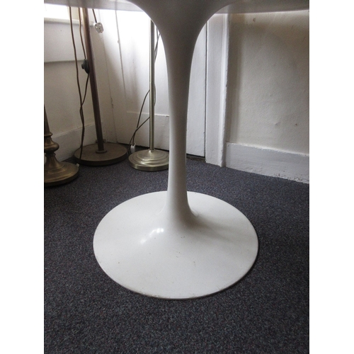 1699 - After Eero Saarinen, a tulip type circular dining table, the white laminate top above a white coated... 