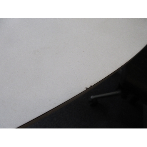1699 - After Eero Saarinen, a tulip type circular dining table, the white laminate top above a white coated... 