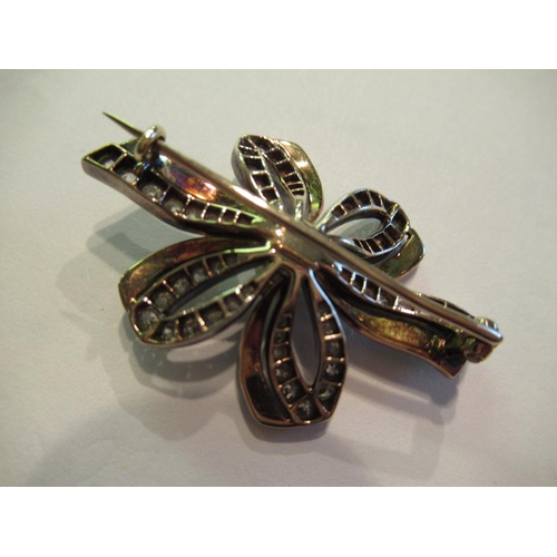 813 - Edwardian gold enamel decorated ribbon brooch set with a single natural pearl and old cut diamonds