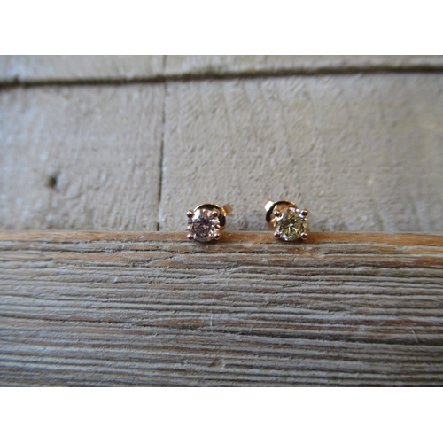 842 - Pair of 18ct rose gold and diamond solitaire ear studs with four claw settings
