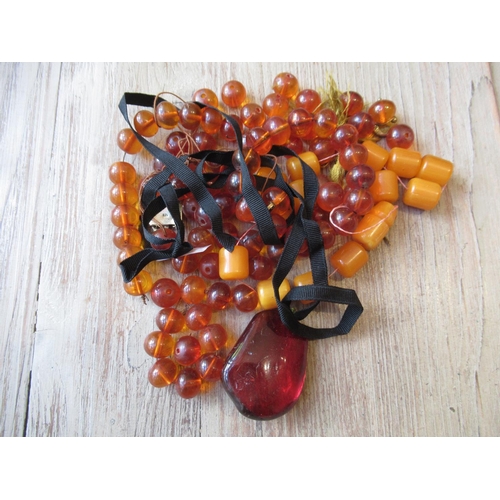 856 - Small re-constituted amber bead necklace and other amber coloured beads etc.