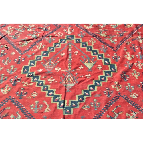22 - Large Kelim carpet with a five medallion and all-over floral stylised design on a red ground with bo... 