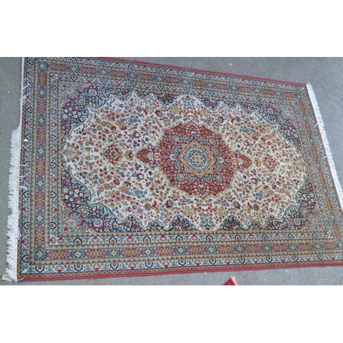 32 - Machine woven Persian design carpet with a medallion and floral design on ivory ground, 10ft x 7ft a... 