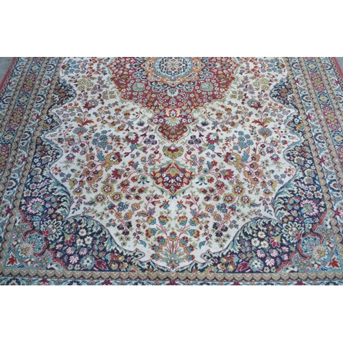 32 - Machine woven Persian design carpet with a medallion and floral design on ivory ground, 10ft x 7ft a... 