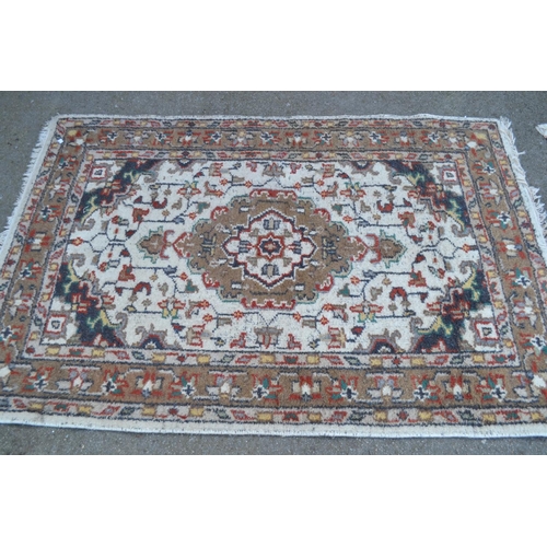 34 - Indian rug with a medallion design on an ivory ground, 6ft x 4ft approximately, together with a smal... 