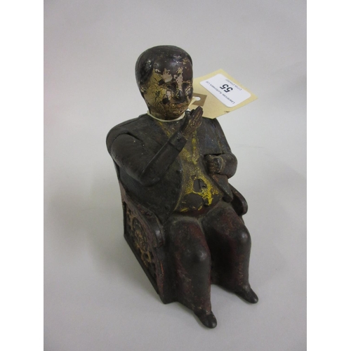 55 - 19th Century painted cast iron ' Tammany ' money bank in the form of a seated gentleman wearing a ja... 