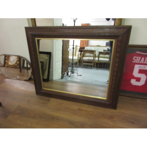 1541 - Rectangular oak framed wall mirror with moulded decoration and gilt inner slip