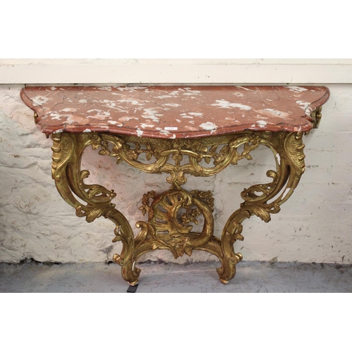 1555 - 19th Century French giltwood console table, the variegated rouge marble top above a pierced floral f... 