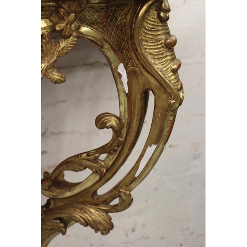 1555 - 19th Century French giltwood console table, the variegated rouge marble top above a pierced floral f... 