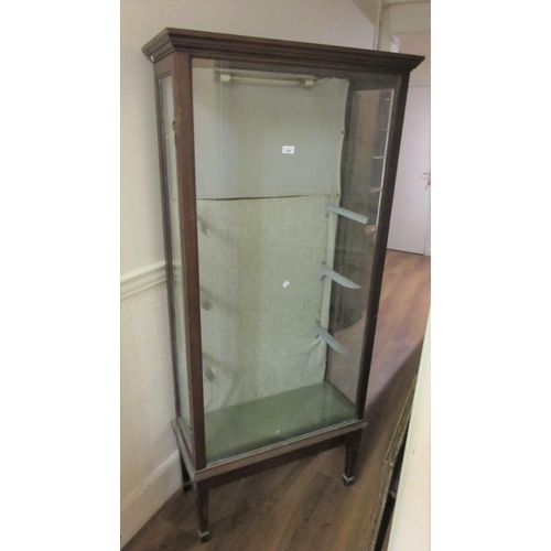 1594 - Early 20th Century mahogany shop display cabinet of tall narrow proportions with side doors, on squa... 