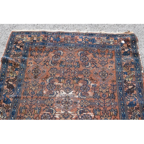 3 - Small Kurdish rug with an all-over stylised floral design on a brick red ground with borders, 4ft 8i... 
