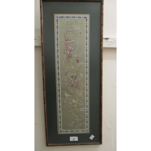34 - 20th Century Chinese silk embroidered sleeve panel, 21ins x 6ins,  in a simulated bamboo frame