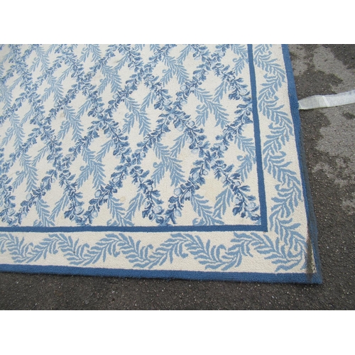 7 - Large modern Chinese machine woven carpet with an all-over blue floral lattice design on an ivory gr... 