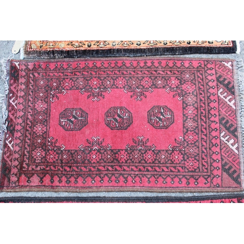 22 - Small Afghan Ziegler mat with a floral design on a dark ground, 2ft 10ins x 2ft 2ins approximately, ... 