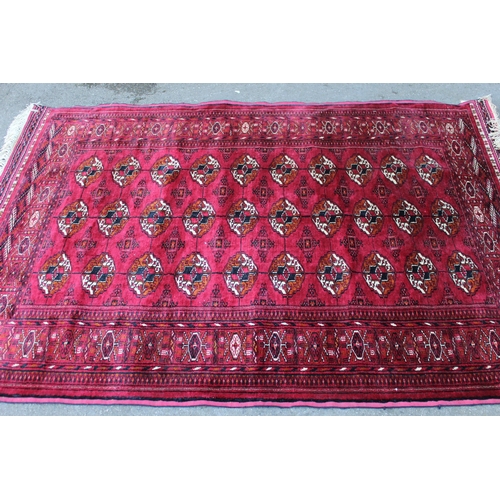 27 - Silk Tekke rug with three rows of ten gols on a wine red ground with borders, 75ins x 54ins approxim... 