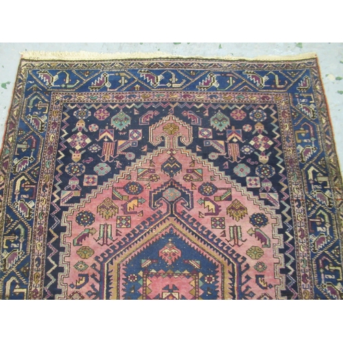 19 - Shiraz carpet with a triple pole medallion and all-over stylised design on a red ground with multipl... 