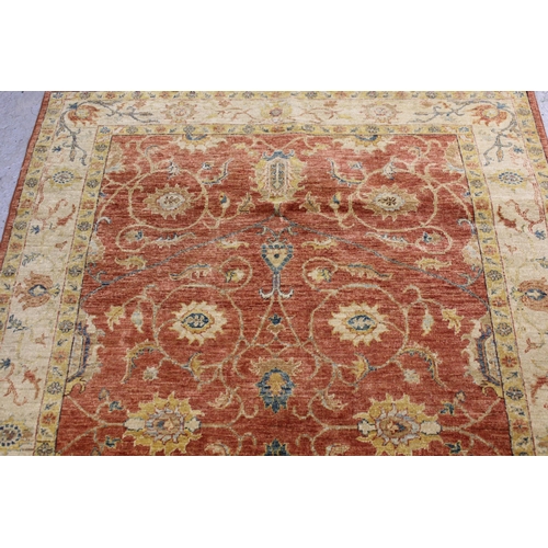 33 - Kurdish rug with centre medallion and all-over floral design on a dark red ground with borders, appr... 