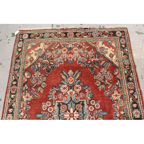 12 - Sarouk rug with a medallion and floral design, on rose ground with borders, 6ft 8ins x 4ft 6ins appr... 