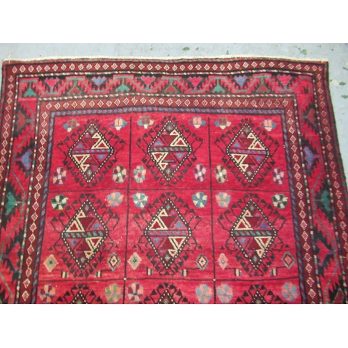 18 - Modern Belouch style rug with an all over hooked medallion and panel design on a red ground with rec... 