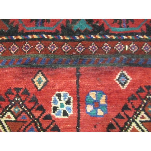 18 - Modern Belouch style rug with an all over hooked medallion and panel design on a red ground with rec... 
