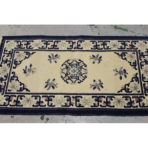 23 - Small Chinese rug with floral design on yellow ground, 5ft 8ins x 3ft 2ins approximately together wi... 