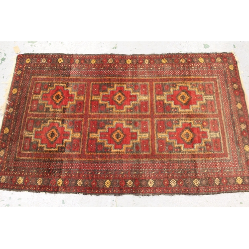 25 - Pakistan rug of Bokhara design with three rows of gols on a red ground with borders, 6ft 2ins x 4ft ... 