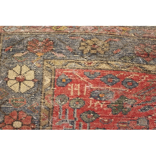 28 - Hamadan rug of all-over floral design with multiple borders on a red ground, 80ins x 40ins