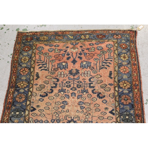 28 - Hamadan rug of all-over floral design with multiple borders on a red ground, 80ins x 40ins