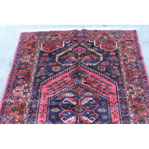 3 - Zanjan rug with a medallion and all-over stylised design on a dark ground with borders, 2.06m x 1.4m