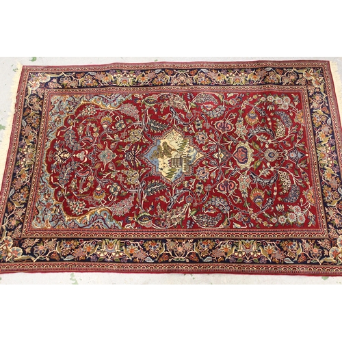 34 - Qum rug with a pictorial centre medallion and all over stylised floral design on wine red ground wit... 