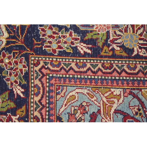 34 - Qum rug with a pictorial centre medallion and all over stylised floral design on wine red ground wit... 