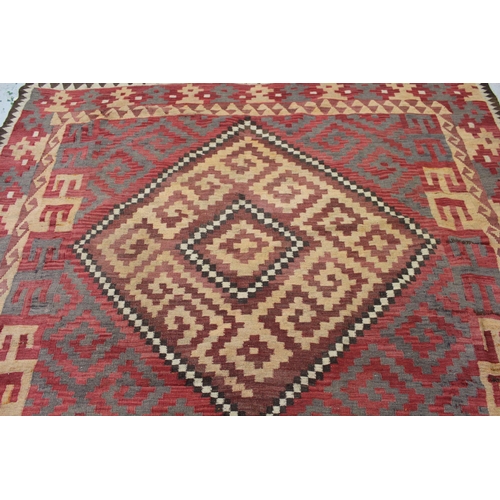 40 - Kelim carpet with a twin medallion and all over stylised stepped and hooked design, on a red ground ... 