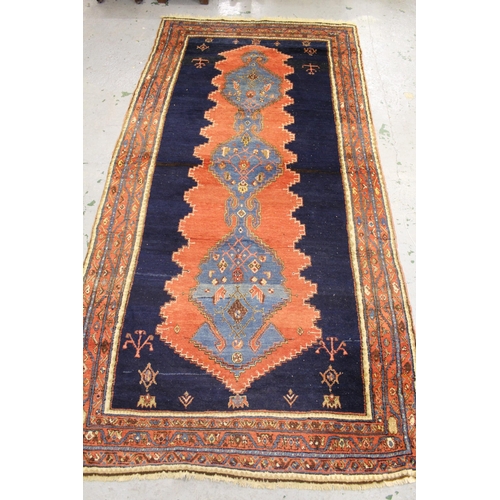 49 - Large Hamadan rug with a triple pole medallion design on a brick red and midnight blue ground with t... 