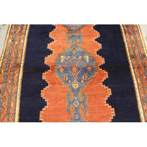49 - Large Hamadan rug with a triple pole medallion design on a brick red and midnight blue ground with t... 