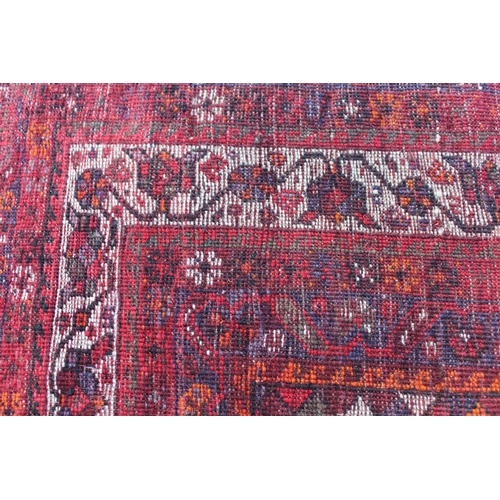 5 - Shiraz carpet with a triple pole medallion and all-over stylised design on a red ground with multipl... 