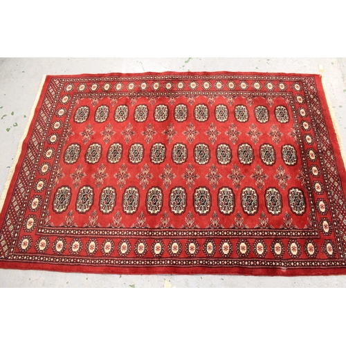 7 - Two Pakistan Bokhara rugs on wine ground, each approximately 70ins x 48ins