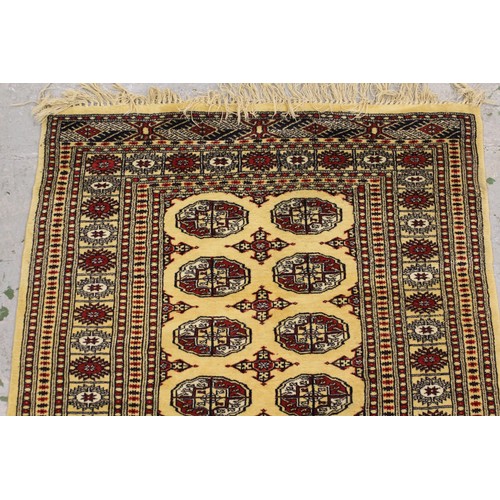 11 - Small Pakistan Bokhara design rug, with two rows of gols, on a ivory ground with borders, 5ft 4ins x... 