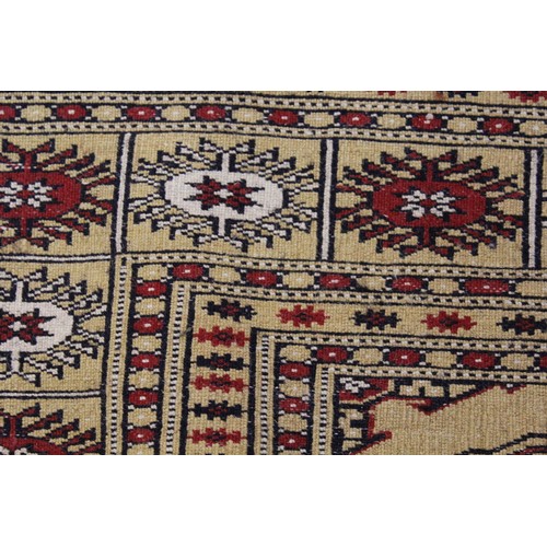 11 - Small Pakistan Bokhara design rug, with two rows of gols, on a ivory ground with borders, 5ft 4ins x... 